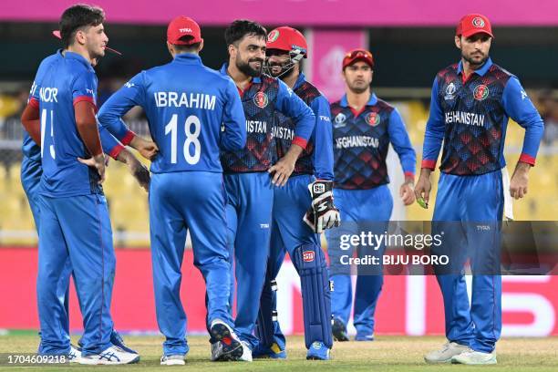 Afghanistan's Rashid Khan celebrates with teammates after taking the wicket of Sri Lanka's Lahiru Kumara during a warm-up match between Afghanistan...