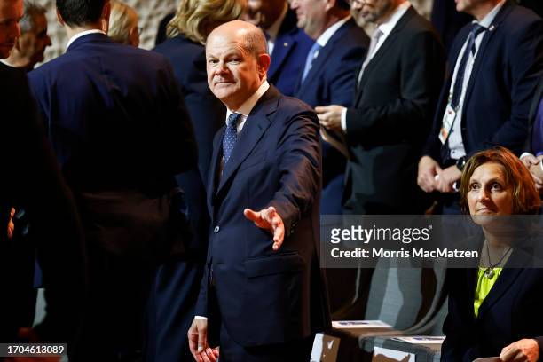 German Chancellor Olaf Scholz gestures as he arrives to a ceremony in Hamburgs Elbphilharmonie opera house as part of the celebrations on German...