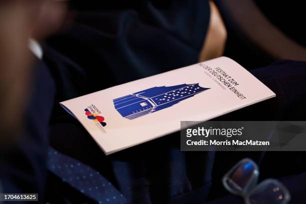 The Program booklet is seen during a ceremony in Hamburgs Elbphilharmonie opera house as part of the celebrations on German Unity Day on October 3,...