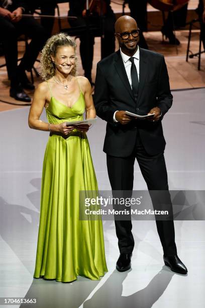 Hosts actress Rhea Harder-Vennewald and TV Presenter Yared Dibaba address the audience during a ceremony in Hamburgs Elbphilharmonie opera house as...