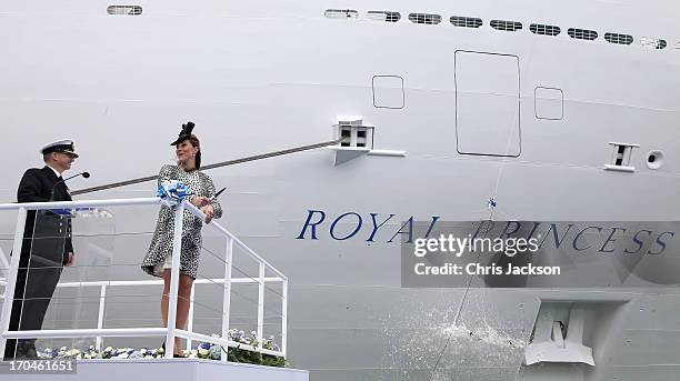 Captain Tony Draper and Catherine, Duchess of Cambridge watch the bottle of Moet & Chandon Brut Imperial Champagne break against the ship for the...