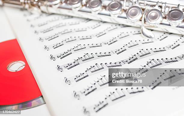 flute keys and cd on music notes - nobod stock pictures, royalty-free photos & images