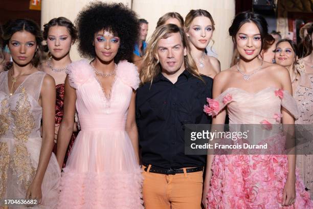 Designer Christophe Guillarme, with Ophély Mézino, acknowledges the audience during the Christophe Guillarme Womenswear Spring/Summer 2024 show as...