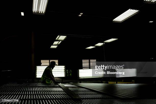 Worker inspects composite decking boards at the Trex manufacturing facility in Winchester, Virginia, US, on Wednesday, June 7, 2023. Trex Co. Turns...