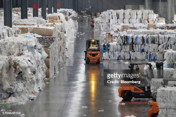 Workers unload bundles of recycled plastics at the Trex manufacturing facility in Winchester, Virginia, US, on Wednesday, June 7, 2023. Trex Co....