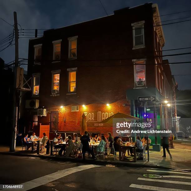 Diners eat outside on the sidewalk at local Italian restaurant, September 9, 2023 in the Red Hook neighborhood of Brooklyn, New York.