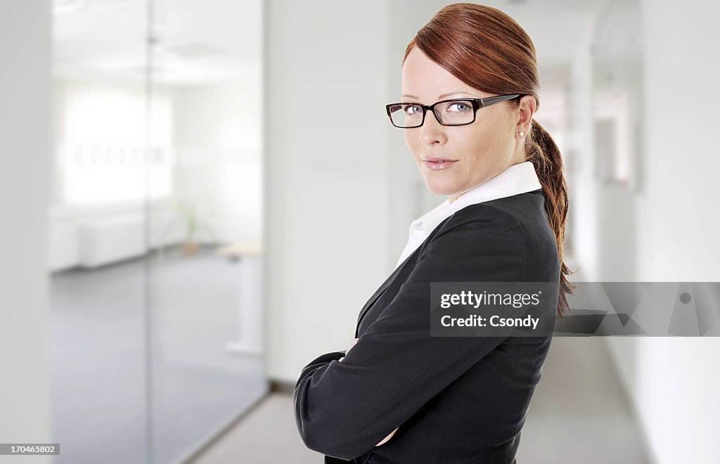 Attractive businesswoman with her arms crossed