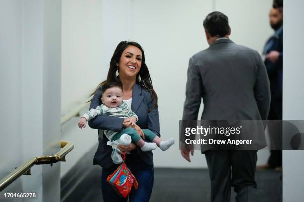 Rep. Lauren Boebert holds her grandson as she leaves a House Republican caucus meeting at the U.S. Capitol October 3, 2023 in Washington, DC. U.S....
