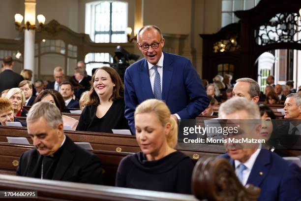 Leader of Germany's Christian Democratic Union CDU Friedrich Merz and Co-leader of Germany's Green party Ricarda Lang attend a religious service at...