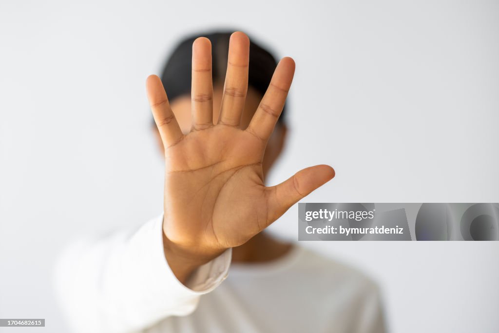 Worried concerned woman making hand stop gesture