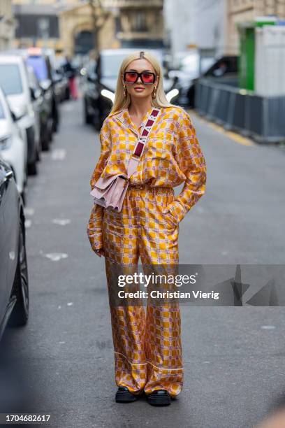 Guest wears yellow button shirt, pants, pink bag outside Marni during the Womenswear Spring/Summer 2024 as part of Paris Fashion Week on September...