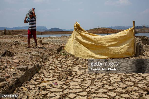 Resident fetches water at Jatigede Reservoir during dry season on October 3, 2023 in Darmaraja, Sumedang Regency, West Java. Almost three months, the...