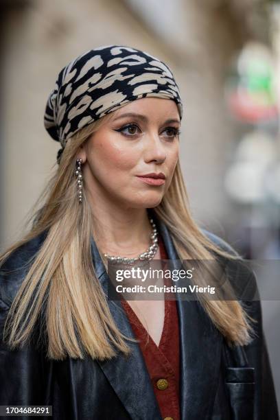 Joicy Muniz wears head scarf, black oversized leather jacket, necklace during the Womenswear Spring/Summer 2024 as part of Paris Fashion Week on...