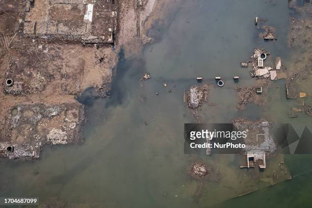 Aerial view show of settlements that surfaced on the shores of the Jatigede Reservoir during dry season on October 3, 2023 in Darmaraja, Sumedang...