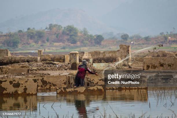 Man cathing a fish at Jatigede Reservoir during dry season on October 3, 2023 in Darmaraja, Sumedang Regency, West Java. Almost three months, the...