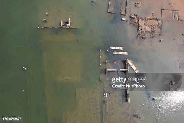 Aerial view show of settlements that surfaced on the shores of the Jatigede Reservoir during dry season on October 3, 2023 in Darmaraja, Sumedang...