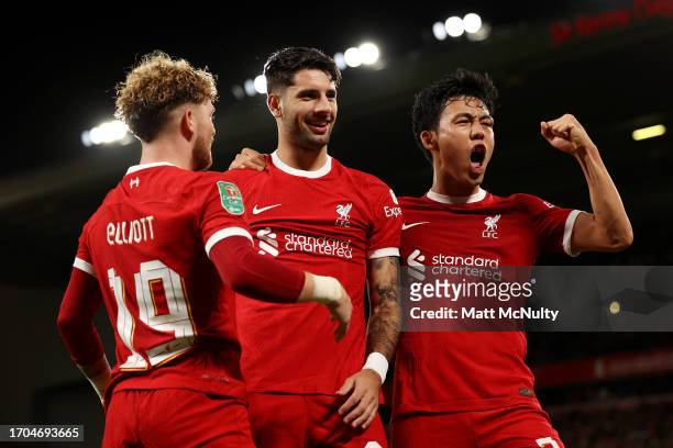 Dominik Szoboszlai of Liverpool celebrates with teammates Harvey Elliott and Wataru Endo after scoring the team's second goal during the Carabao Cup...