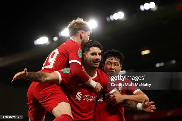 Dominik Szoboszlai of Liverpool celebrates with teammates Harvey Elliott and Wataru Endo after scoring the team's second goal during the Carabao Cup...