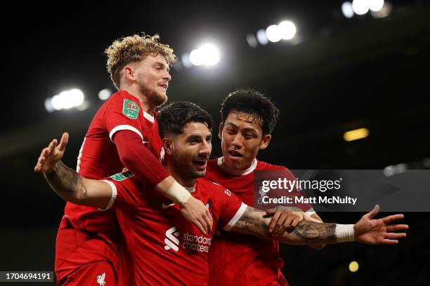 Dominik Szoboszlai of Liverpool celebrates with teammates Harvey Elliott and Wataru Endo after scoring the team's second goal during the Carabao Cup...