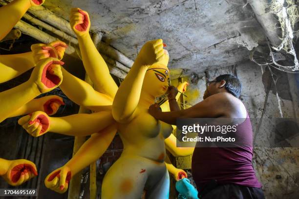 Artisan are seen busy preparing idols of Goddess Durga ahead of Durga puja festival in Kolkata , India , on 3 October 2023 .