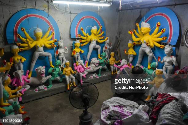 Artisan are seen busy preparing idols of Goddess Durga ahead of Durga puja festival in Kolkata , India , on 3 October 2023 .