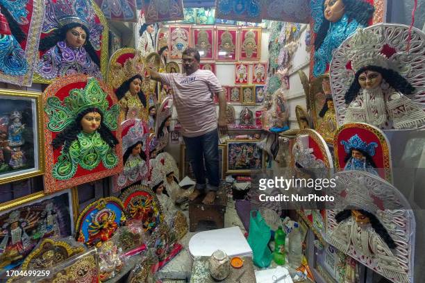 Shopkeeper is seen setting up shop which sales various Styrofoam art pieces of goddess Durga , ahead of Durga puja festival in Kolkata , India , on 3...
