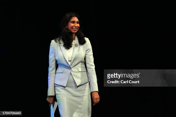 Britain's Home Secretary Suella Braverman walks on stage to deliver her speech on the third day of the Conservative Party Conference on October 03,...