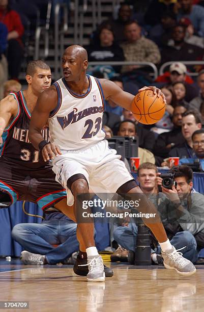 Guard Michael Jordan of the Washington Wizards drives against forward Shane Battier of the Memphis Grizzlies during the game at MCI Center on...