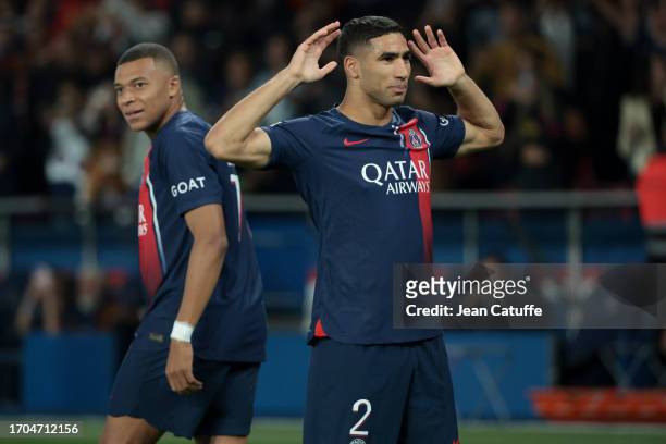 Achraf Hakimi of PSG celebrates his goal while Kylian Mbappe looks on during the Ligue 1 Uber Eats match between Paris Saint-Germain and Olympique de...