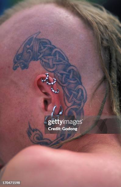 Young English man with piercings and tatoos, Great Britain.