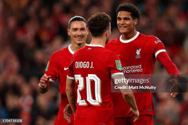 Diogo Jota of Liverpool celebrates with teammates Darwin Nunez and Jarell Quansah after scoring the team's third goal during the Carabao Cup Third...