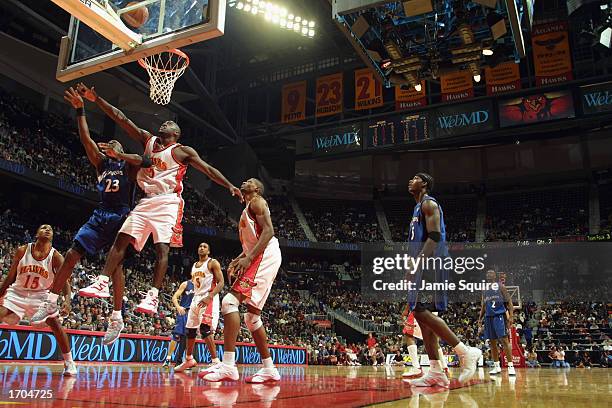 Guard Michael Jordan of the Washington Wizards battles for a rebound against forward Dion Glover of the Atlanta Hawks during the first half of the...
