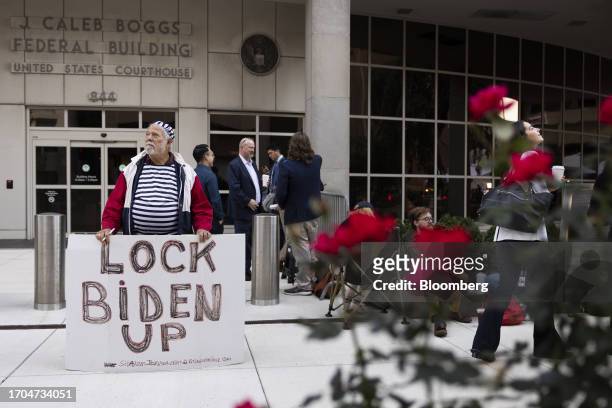 Demonstrator outside the J. Caleb Boggs Federal Courthouse ahead of Hunter Biden's arrival in Wilmington, Delaware, US, on Tuesday, Oct. 3, 2023....