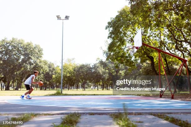 young black basketball player - jump shot stock pictures, royalty-free photos & images