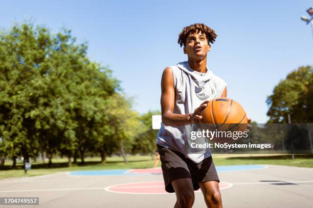 young black basketball player - jump shot stock pictures, royalty-free photos & images