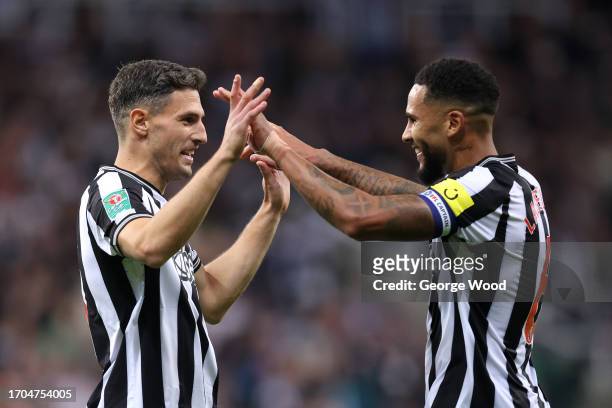 Jamaal Lascelles and Fabian Schar of Newcastle United celebrate following the team's victory during the Carabao Cup Third Round match between...