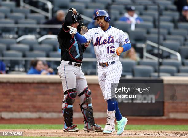 Francisco Lindor of the New York Mets celebrates his two run home run as Nick Fortes of the Miami Marlins looks on in the third inning during game...