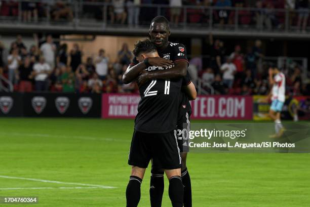 Theodore Ku-Dipietro of D.C. United celebrates his score with teammate Christian Benteke of D.C. United during a game between Chicago Fire FC and...