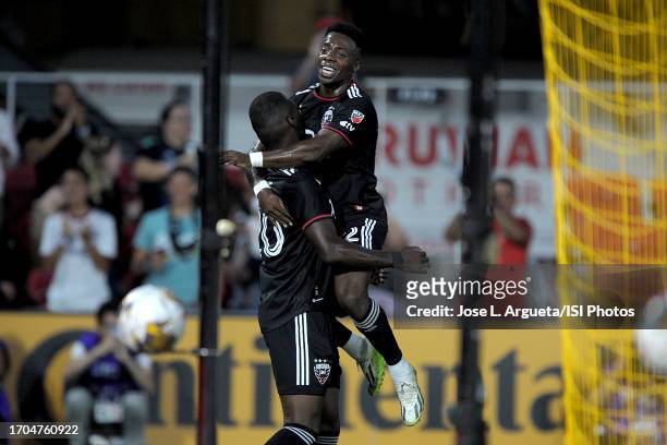 Christian Benteke of D.C. United celebrates his score with teammate Christian Dajome of D.C. United during a game between Chicago Fire FC and D.C....