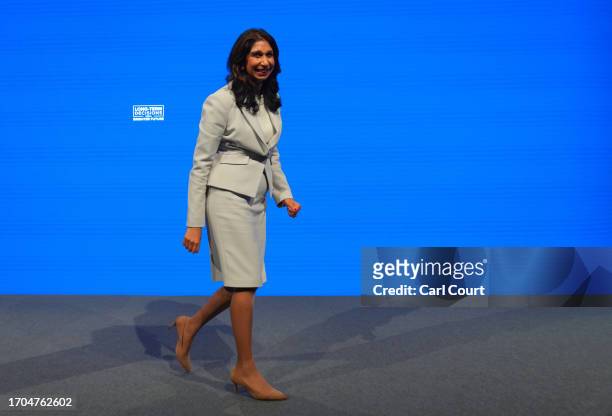 Britain's Home Secretary, Suella Braverman, leaves the stage after delivering her speech on the third day of the Conservative Party Conference on...