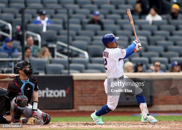 Francisco Lindor of the New York Mets hits a two run home run as Nick Fortes of the Miami Marlins defends in the third inning during game one of a...
