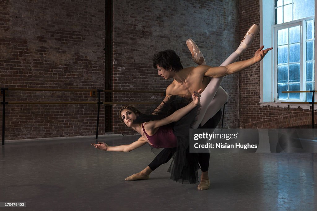 Ballet dancers performing ballet fish lift