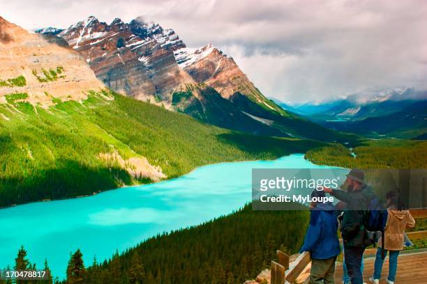 Tourists on the observation deck overlooking Peyto Lake on the Ice fields Parkway in Banff National Park.