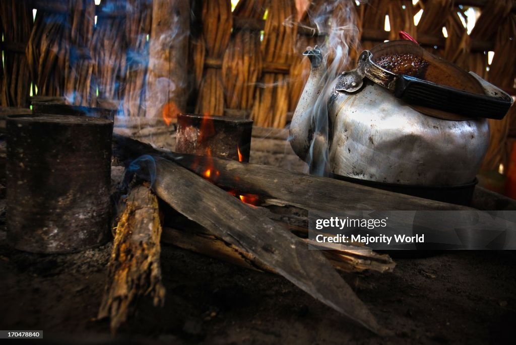 A traditional firewood stove and a kettle, at a hut, in the vill