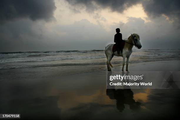 Horses can be rent at the Coxs Bazaar beach for riding. Coxs Bazaar, Bangladesh. April 18, 2009.