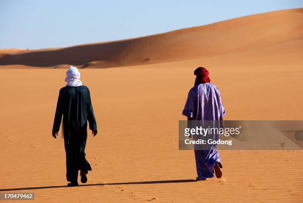 Tuaregs walking in the desert, Sebha, Lybia.