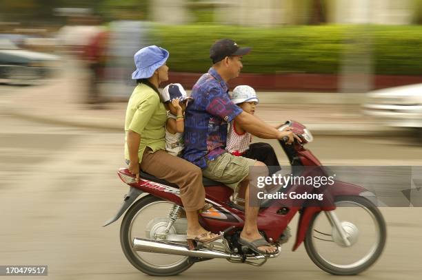 Cambodian family on a motorcycle, Phnom Penh, Cambodia.