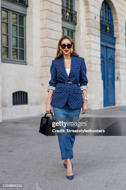 Influencer Alexandra Lapp, wearing a Gucci blazer, a Zara long jeans skirt, a Saint Laurent Le 37 bag, Christian Louboutin So Kate heels in denim, a...