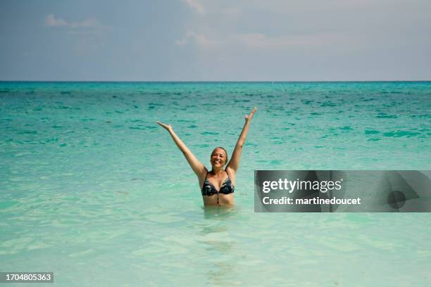 beautiful 50+ woman enjoying being in the ocean. - cuba stock pictures, royalty-free photos & images