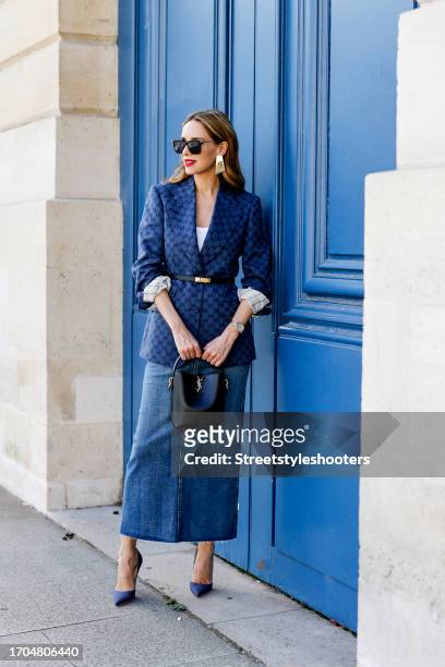 Influencer Alexandra Lapp, wearing a Gucci blazer, a Zara long jeans skirt, a Saint Laurent Le 37 bag, Christian Louboutin So Kate heels in denim, a...